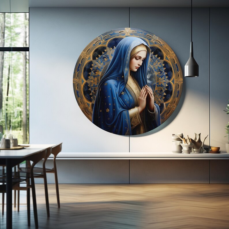 May include: A round painting of a woman in a blue robe with a gold trim, praying with her hands clasped. The background is a gold and blue mandala design.