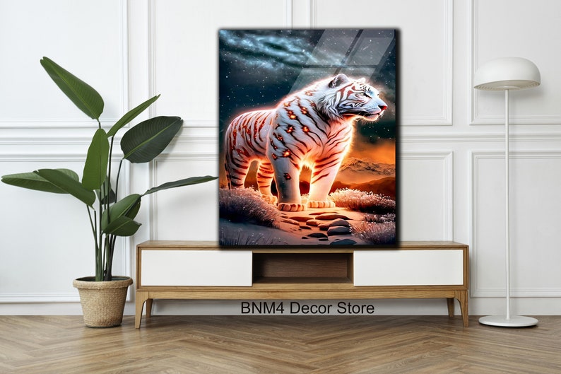 May include: A white tiger with orange stripes stands on a rocky path in a snowy landscape. The tiger's eyes glow with a fiery orange light. The background is a dark blue sky with stars.