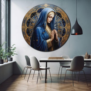 May include: A round painting of a woman in a blue robe with gold accents, praying with her hands clasped. The background is a circular stained glass design with gold and blue colors.