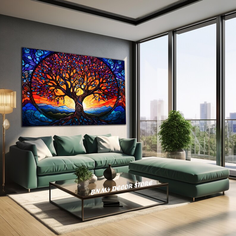 May include: A colorful stained glass style painting of a tree with a sunset background. The tree is in the center of the painting and has a large trunk and many branches. The sunset is behind the tree and is a mix of orange, yellow, and red colors. The painting is hanging on a wall in a living room setting.