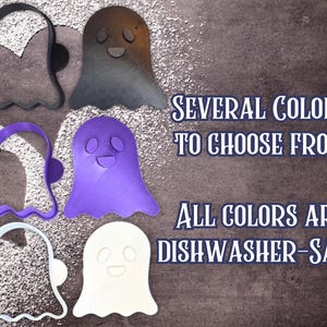 May include: A collection of ghost-shaped cookie cutters in various colors, including black, purple, and white. The image also displays a ghost in a gradient of brown and gray. Text on the image reads "Several colors to choose from" and "All colors are dishwasher-safe!"
