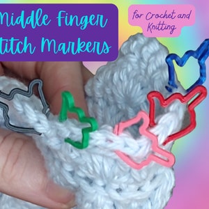 May include: A set of colourful middle finger stitch markers for crochet and knitting. The markers are made of plastic and are shaped like a middle finger. They are a fun and unique way to mark your stitches.