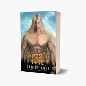 May include: Book cover featuring a man with long blonde hair and a glowing tattoo on his chest. The title is "Hands of Fate" and the author is "Regine Abel".
