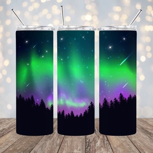 006. Northern Lights / Shooting stars.  Beautiful colors.  Black Trees at Bottom. Finished 20 oz. Skinny Tumbler.