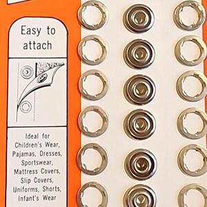 May include: A package of 7 silver Dritz Dot Snappers refill for use with Dritz Plier Kits or Dritz Dot Snappers. The package is orange and white and says "30c" and "RUSTPROOF! LAUNDRYPROOF!"
