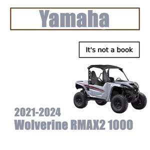Puede incluir: Un vehículo todoterreno Yamaha Wolverine RMAX2 1000 de color gris claro. La imagen incluye el texto "Yamaha" y "It's not a book". El vehículo tiene neumáticos negros y una jaula antivuelco negra. También está presente el texto "2021-2024".