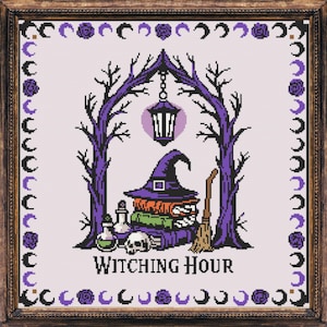 May include: Cross-stitch art in a wooden frame. The design features a witch's hat, books, a skull, and potion bottles. The words "Witching Hour" are at the bottom. The color scheme includes purple, black, and green.