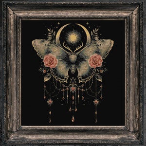 May include: A framed cross-stitch design featuring a moth with a crescent moon and stars, surrounded by roses and a dangling chain of jewels. The background is black.
