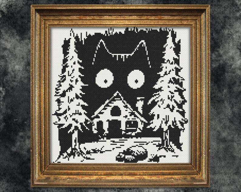 May include: Black and white cross-stitch pattern of a cat's face peeking out from behind a small house and trees. The cat has large, round eyes and a surprised expression.