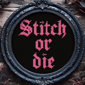 May include: A framed cross-stitch design with the words "Stitch or Die" in pink against a black background. The frame is ornate, black, and circular, set against a rustic wooden surface.
