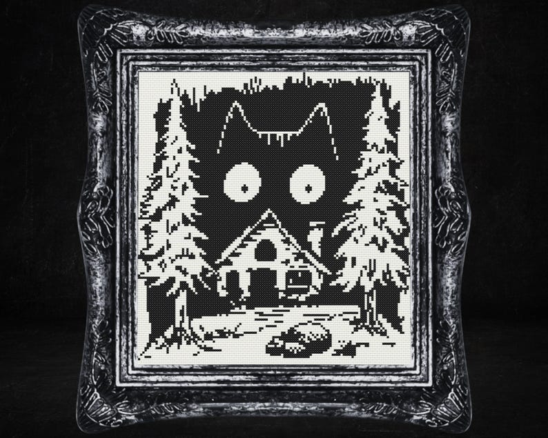 May include: Black and white cross-stitch pattern of a cat's face with large eyes, a small house, and trees in the background.