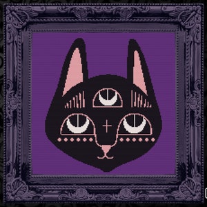 May include: A framed cross-stitch design of a black cat with three eyes and pink details. The cat is set against a purple backdrop and framed in a dark, ornate frame. The image has a gothic aesthetic, suitable for home decor.