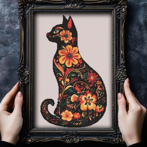 May include: Black cat silhouette with intricate floral patterns in shades of orange, yellow, and green. The cat is facing left and has a stylized design.