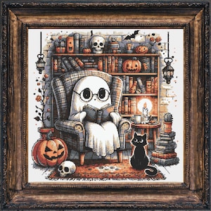 May include: A framed print depicts a ghost wearing glasses, reading in a cozy armchair. A black cat sits nearby. The scene includes a bookshelf, pumpkins, a skull, and a lit candle, creating a Halloween theme.