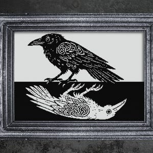May include: A framed black and white artwork featuring a raven. The raven is depicted in a detailed, stylized design, with a reflection below. The artwork is in a dark, ornate frame, suitable for gothic or nature-themed decor.