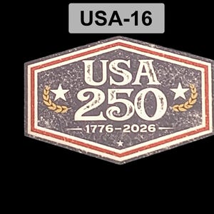 May include: A commemorative emblem with the text "USA 250" and the years "1776-2026". The design features a red, white, and blue color scheme, with stars and laurel wreaths. The emblem is in a hexagonal shape.