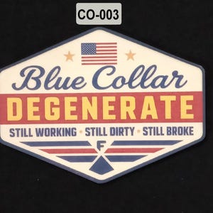 May include: A white, blue, red, and yellow sticker with the text "Blue Collar Degenerate" and the American flag. The sticker also includes the phrases "Still Working, Still Dirty, Still Broke."