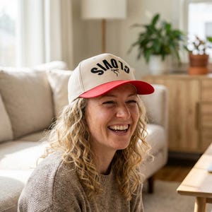 May include: A white ceramic mug with a black handle and the text "But First, Coffee" in a bold, black font. The mug is sitting on a wooden surface. The mug is approximately 4 inches tall.