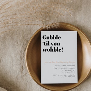 May include: A white card with black text that reads "Gobble 'til you wobble!"  Join us for Friendsgiving Dinner.  October 8th, 2023 | 2PM.  At the Smith Residence, 123 Anywhere St., Any City, ST 12345.  RSVP to Anna by October 1st, 123-456-7890.