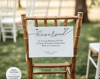 May include: A white sign with the word "Reserved" in elegant script is attached to a wooden chair. The sign includes the text "In Loving Memory Of Our Friends & Family Celebrating With Us In Heaven" and the date 27.06.2026. The sign is available in 5x7" and 8x10" sizes.