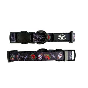 May include: Black dog collar with a repeating pattern of skulls, roses, and other tattoo-style imagery. The collar has a black plastic buckle and a metal D-ring. The text "TUFF BONES PET SUPPLY" is printed on the collar.