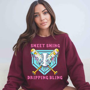 A vibrant and playful baseball-themed design featuring two crossed bats and a baseball, all dripping with colorful icing and sprinkles. The background showcases a bright blue home plate outline, enhancing the bold and energetic look. Perfect for baseball lovers, team logos, and sports-inspired apparel.
