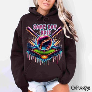 "Vibrant baseball with neon drip effects, surrounded by lightning bolts and crossed bats, with a glowing baseball field below. The words 'Game Day Drip' in bold, colorful font. Perfect for baseball fans and players."