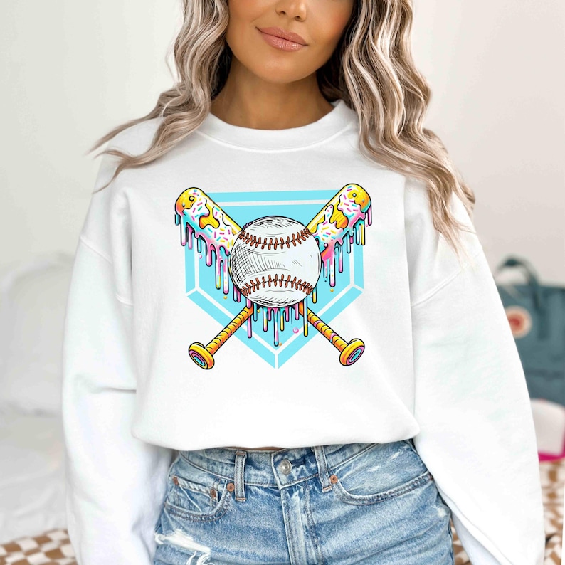 A vibrant and playful baseball-themed design featuring two crossed bats and a baseball, all dripping with colorful icing and sprinkles. The background showcases a bright blue home plate outline, enhancing the bold and energetic look. Perfect for baseball lovers, team logos, and sports-inspired apparel.