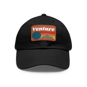 May include: Black baseball cap with a brown patch featuring a retro-style graphic with the word "Venture" in white text and a mountain scene with a sun and rainbow.