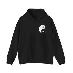 May include: Black hooded sweatshirt with a white yin yang symbol on the front.
