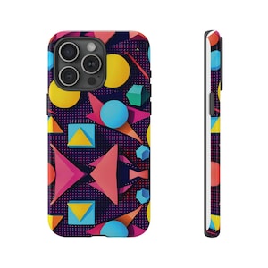 May include: A phone case with a geometric pattern in shades of pink, yellow, blue, and red on a dark blue background. The case has a cutout for the phone's camera.
