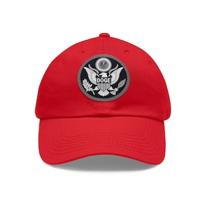 May include: Red baseball cap with a gray and white patch featuring a bald eagle and the word "DOGE" on a red background.