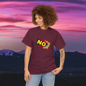 May include: A maroon t-shirt with a graphic of a red and yellow rectangle with the text "Say NO to drugs" in white, green, and yellow letters.