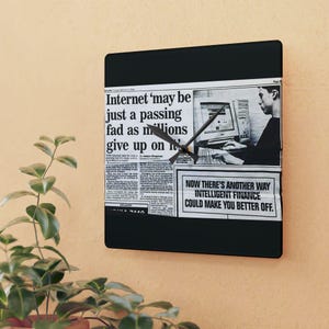 May include: A black clock with a newspaper clipping as the face. The newspaper headline reads "Internet 'may be just a passing fad as millions give up on it'" and the text below reads "NOW THERE'S ANOTHER WAY INTELLIGENT FINANCE COULD MAKE YOU BETTER OFF."