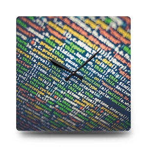 May include: A clock face with a black background and a close-up of colourful code. The clock hands are black and point to the time.