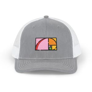 May include: Grey trucker cap with a white mesh back and a curved peak. The front displays a colourful embroidered design of the golden ratio in pink, orange, green, and yellow.