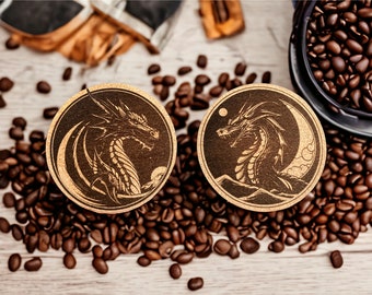 May include: Two round wooden coasters with a dark brown background and a light brown design of a dragon with a crescent moon. The coasters are surrounded by coffee beans.