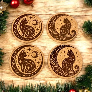 May include: Four round cork coasters with a cat and crescent moon design. The brown coasters feature a detailed illustration of a cat silhouette within a crescent moon, surrounded by stars and decorative swirls. Festive holiday decor surrounds the coasters.