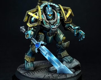 May include: A miniature sci-fi robot figure featuring metallic blue armor with gold trim, a glowing orange eye, and a large blue energy sword. The figure stands on a textured stone-like base with intricate geometric patterns and weathered details.