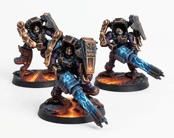 May include: Three miniature sci-fi soldier figurines in dark armor with bronze accents, purple undersuits, and glowing blue energy weapons. Each figure stands on a circular base featuring a textured lava-like surface with orange and black details.