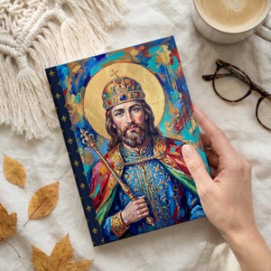 Photograph of St. Stephen of Hungary lined journal, with the prayer typeset on the back cover, navy and gold fleur-de-lis spine, hand flat lay
