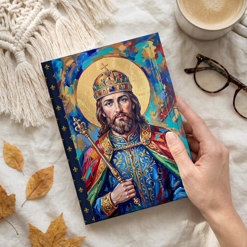 Photograph of St. Stephen of Hungary lined journal, with the prayer typeset on the back cover, navy and gold fleur-de-lis spine, hand flat lay