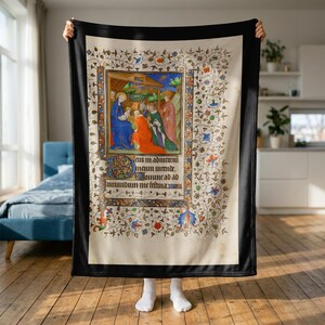 Nativity plush blanket held up to show its full size in a bright room