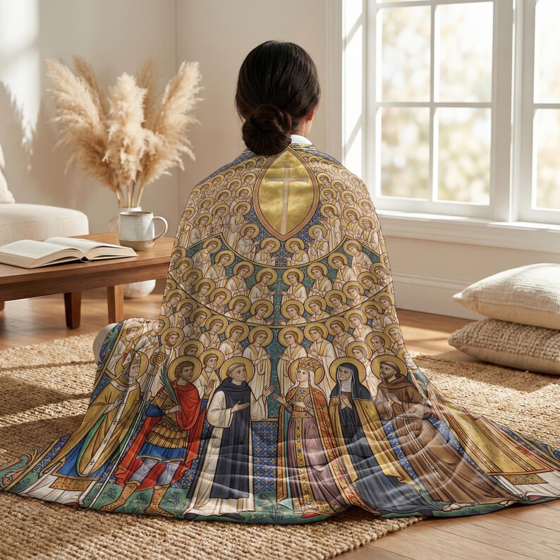 All Saints plush blanket wrapped around a woman's shoulders as she sits on the floor
