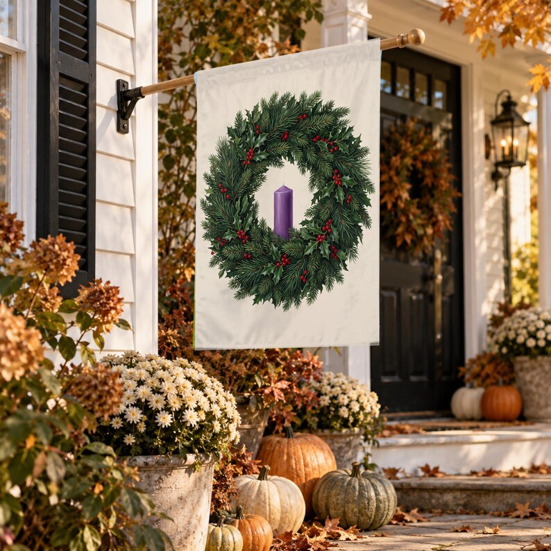 Advent garden flag in the large size, hung from a wall pole beside a front door with an autumn wreath