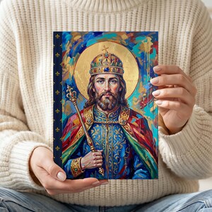 The St. Stephen of Hungary lined journal, with the prayer typeset on the back cover, navy and gold fleur-de-lis spine, model close-up