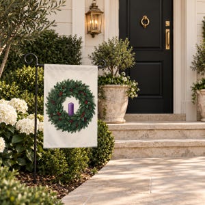 Advent garden flag on a garden stand beside stone steps up to a black front door