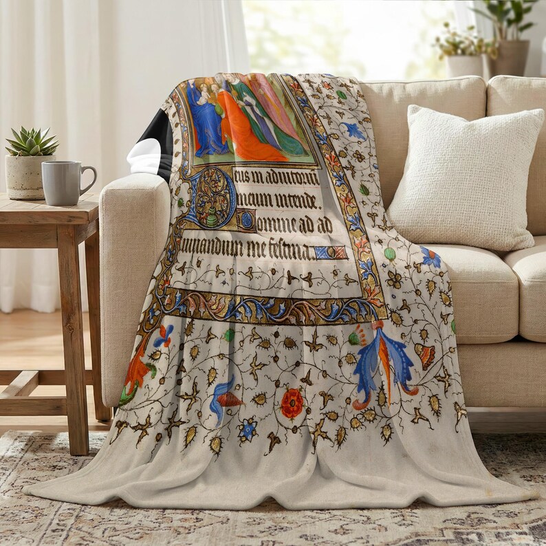 Nativity plush blanket draped over the arm of a cream sofa