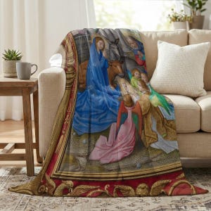 Nativity plush blanket draped over the arm of a cream sofa