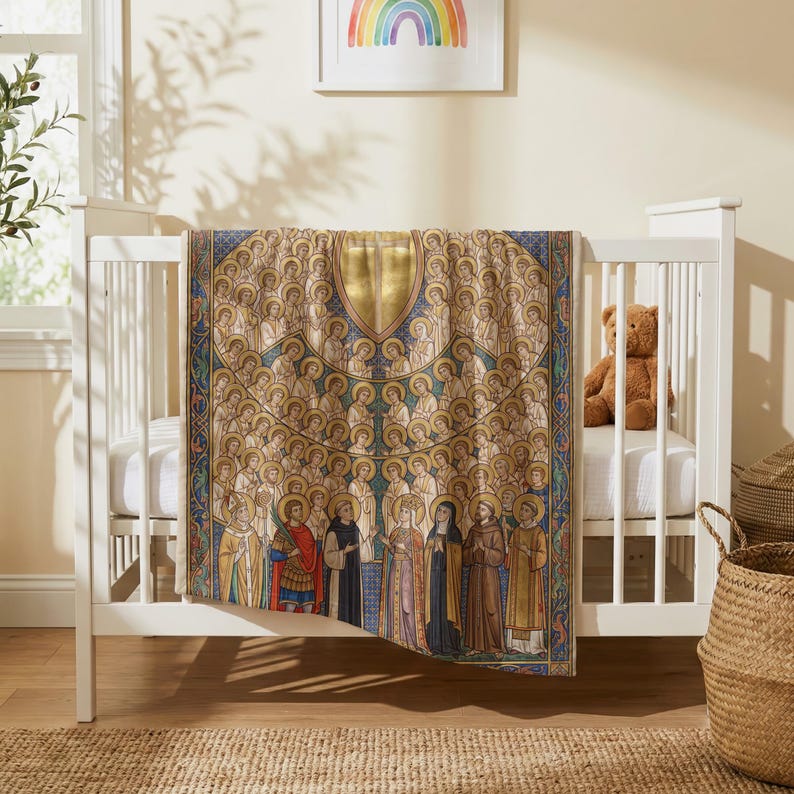 All Saints plush blanket draped over the side of a white crib in a nursery